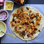Ackee ranch, spicy cauliflower bites and red onions top this #veganpizza