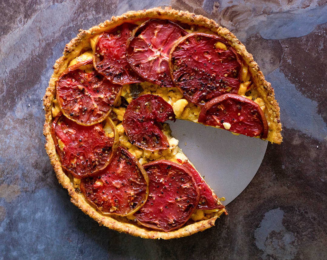 Bite-into-the-ultimate-umami-bomb-from-this-heirloom-tomato-and-ackee-tart,-baked-in-an-aged-cheddar-thyme-crust-it's-an-explosion-of-flavour-in-every-bite
