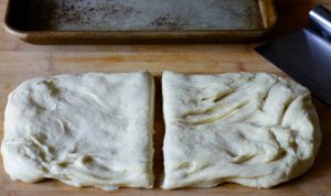 focaccia-dough-cut-in-half-in-preparation-for-making-stuffed-focaccia