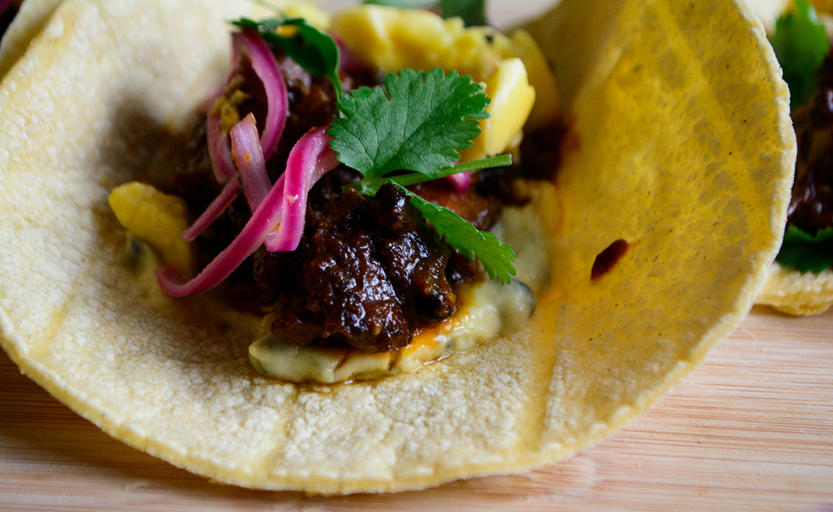 Juicy-oxtail-on-top-buttery-ackee-bean-spread-with-roasted-poblano
