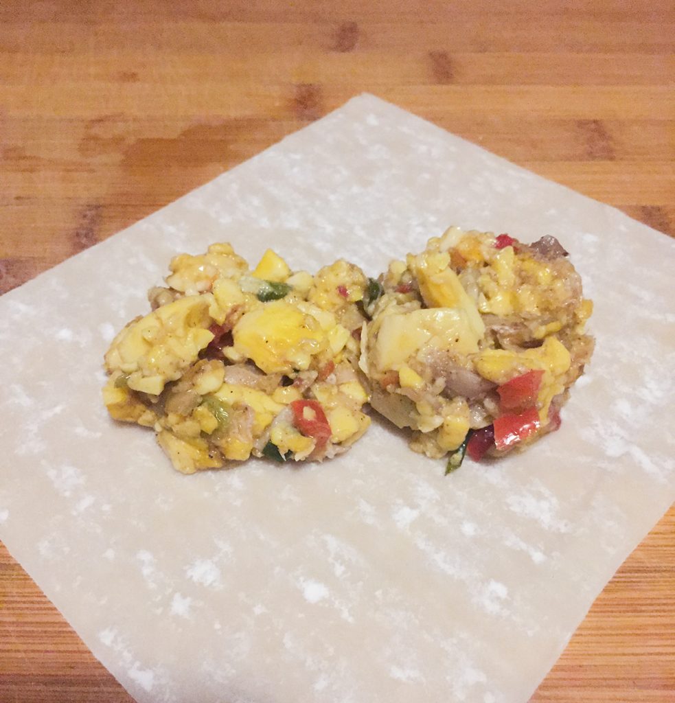 how-to-make-ackee-and-saltfish-springrolls-step-2-use-a-portion-scoop-to-fill-the-spring-rolls
